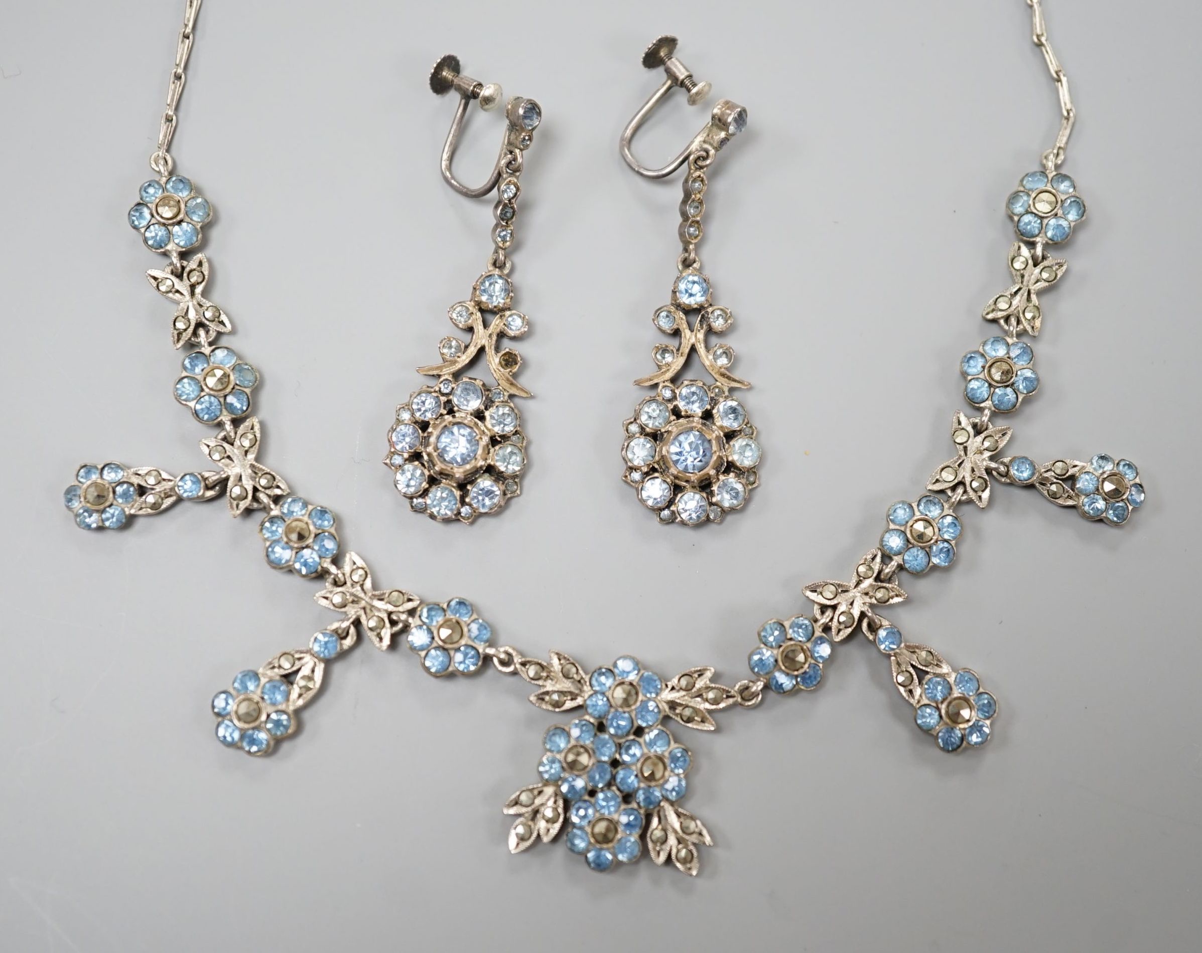 A base metal, marcasite and blue paste set necklace and pair of matching drop earrings, necklace 41cm, earrings 42mm.